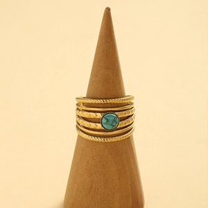 14K gold plated stainless steel multi-layer ring set with turquoise stone on a stand