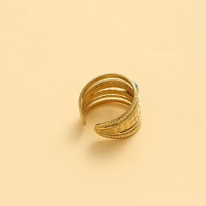 Detail of wide multi-layer gold band ring with round turquoise and beaded edge