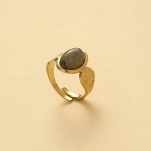 Adjustable gold open ring featuring an oval grey stone with textured band detail