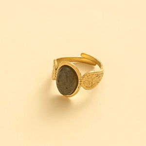 Detail of adjustable gold ring with hammered texture and oval grey labradorite stone