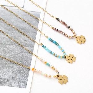 Detailed macro of handmade four-leaf clover necklaces with colorful beads in three styles