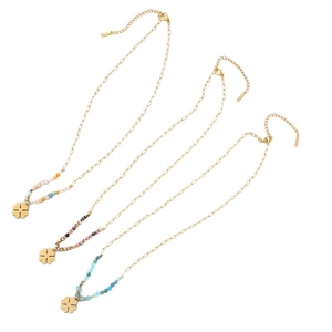 Three gold clover necklaces with colorful beads on a clean white background