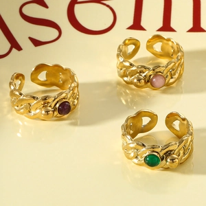 Vintage gold twisted rings set with green, pink, and purple natural stones in retro style