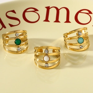 Macro view of multi-layer gold stainless steel rings with colorful natural stones and crystals