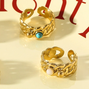 Detail of gold braided chain rings with blue turquoise and white pearl accents