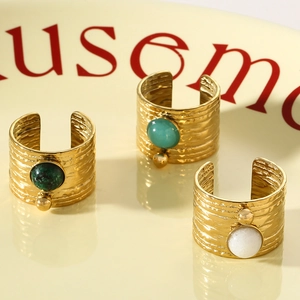Vintage gold textured open rings featuring inset green, turquoise and white stones