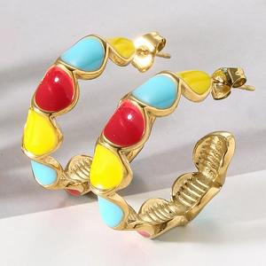 Close-up of C-shaped earrings with colorful red, yellow, and blue enamel links