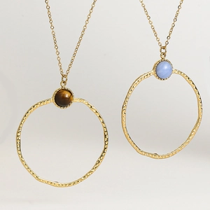 Detail of 18K gold plated hammered pendants with tiger eye and light blue natural stones