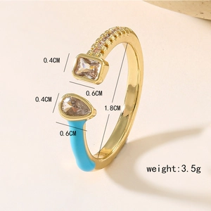 Detailed shot of gold-plated open ring with blue enamel and cubic zirconia stones