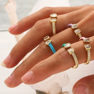 Macro shot of colorful enamel copper rings with teardrop and rectangular zircons