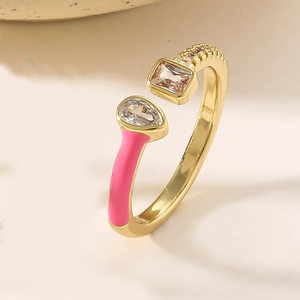 Detail of pink enamel ring with pear and rectangle shaped cubic zirconia stones
