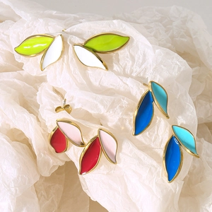 Detailed view of colorful leaf-shaped earrings with gold trim and enamel filling