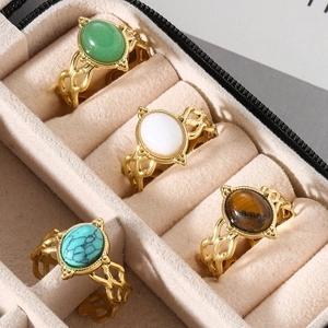 Detail view of retro hollow rings with green, blue, white, and brown gemstones