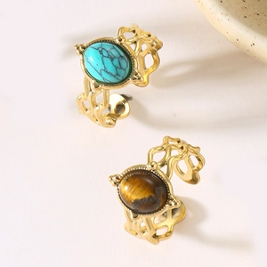Detail of vintage bohemian open rings with turquoise and tiger eye stone inlay