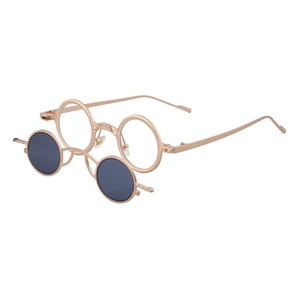Retro steampunk round sunglasses with gold metal frame and flip-up lenses on white background