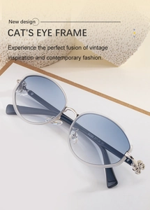 Close-up of cat-eye sunglasses with gradient blue lenses and silver flower hinge detail