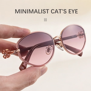 Detail of rose gold cat eye sunglasses featuring pink gradient lenses and floral hinge
