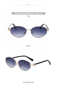 Close-up of golden metal oval sunglasses with gradient gray lenses and clover hinge