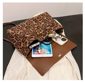 Internal view of a leopard print crossbody bag showing large storage space for tablets