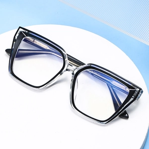 Cat eye blue light blocking glasses with clear resin and black frames on a stone stand