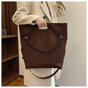 Brown vintage tote bag detail showing mixed textures and sturdy rope handle lifestyle view