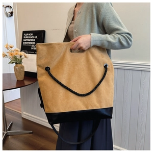 Detail of contrast stitching and mixed materials on the coffee faux suede tote bag