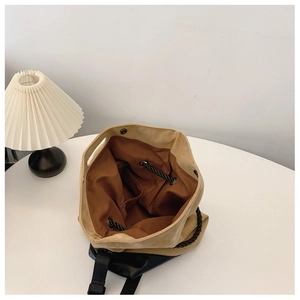 Top view of two-tone tote bag interior showing spacious brown lining and button closure