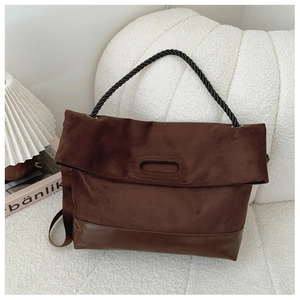 Detail of vintage brown suede tote with unique black twisted rope handle and leather base