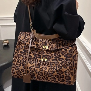 Leopard print large tote bag with brown leather handles and gold clasp lock detail