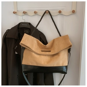 Detail of contrast stitching tote bag with suede texture and woven rope handle
