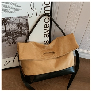 Close-up of retro brown faux suede tote with black leather trim and rope handle detail