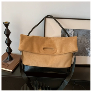 Detail of khaki suede tote bag with black leather base and thick rope handle design