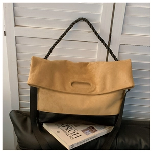 Detail of vintage large tote bag with ginger suede and black leather patchwork design