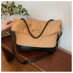 Detail of a large color-block tote bag with suede texture and adjustable shoulder strap