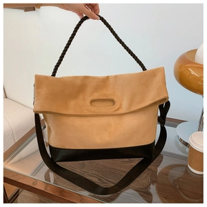 Detail of vintage large tote bag showing suede texture, knotted handle and wide strap
