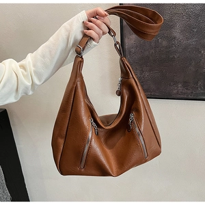 Detailed view of brown vintage hobo bag in soft PU leather with diagonal silver zippers