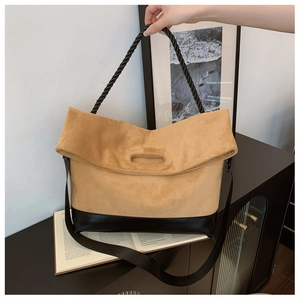 Detail of camel suede and black leather tote bag with thick rope handle and strap