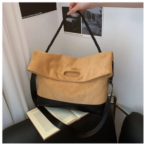 Close-up of retro contrast hobo bag featuring suede splicing and woven rope handles