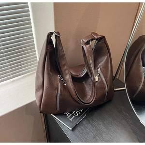 Detailed view of vintage dark brown PU leather hobo bag with dual silver zippers