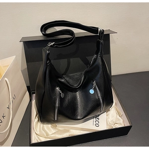 Macro detail of high-quality black faux leather Hobo bag with silver zipper accents