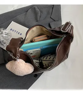 Detailed interior of a large brown tote bag showing capacity for a tablet and accessories