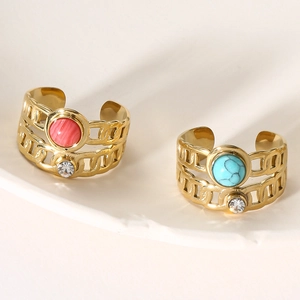 Detailed macro of vintage adjustable gold rings with pink and turquoise stones