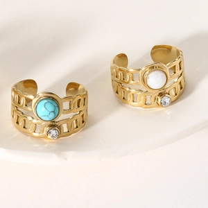 Detail of vintage gold open rings with turquoise and white stone inlay with crystals
