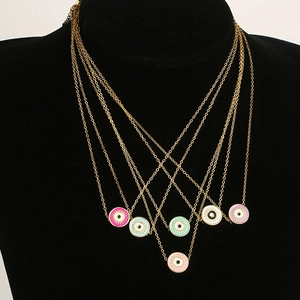 Detail of colorful enamel evil eye pendants on gold chains for women jewelry