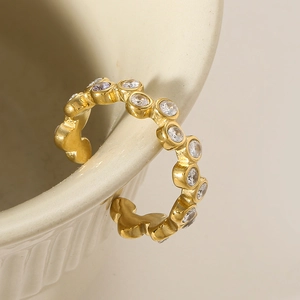 French vintage gold open ring with zircons hanging on a ceramic cup edge