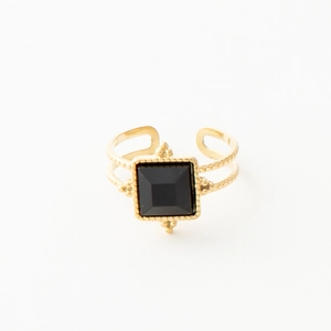 Detail of vintage gold open ring with square black stone and milgrain textured band
