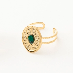 Detail of vintage gold open ring with green oval stone and sunburst relief engraving