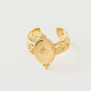 Detail of 18k gold plated stainless steel ring with star engraving and braided band