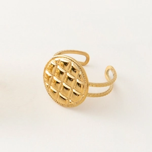 Detailed view of adjustable gold-plated stainless steel ring with quilted oval pattern