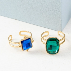 Detail of 18k gold plated adjustable rings with emerald green and navy blue zircon gems